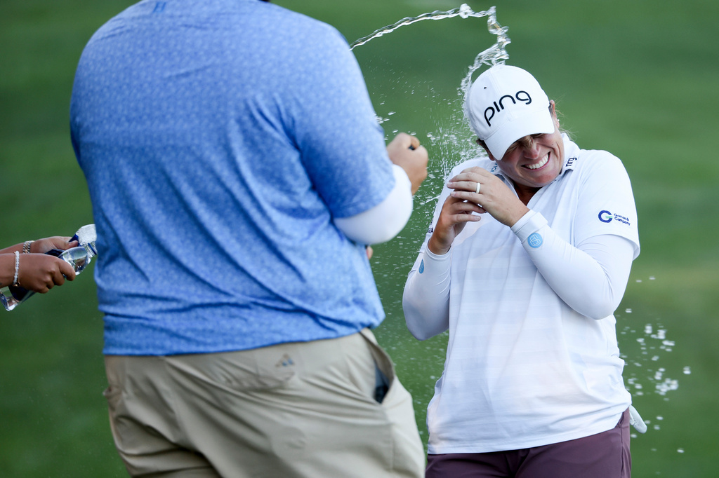 Lauren Coughlin gets sprayed with water after winning the Aramco Championship golf tournament Sunday, April 5, 2026, in North Las Vegas, Nev. (AP Photo/Ian Maule)