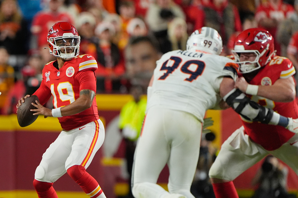 Kansas City Chiefs quarterback Chris Oladokun (19) looks to pass as teammate center Creed Humphrey, right, blocks Denver Broncos defensive end Zach Allen (99) during the first half of an NFL football game Thursday, Dec. 25, 2025, in Kansas City, Mo. (AP Photo/Charlie Riedel)