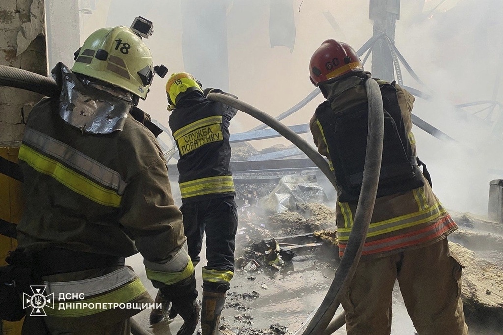 In this photo provided by the Ukrainian Emergency Services on Saturday, Sept. 20, 2025, rescue workers put out a fire of a residential house damaged by a Russian strike on Dnipro, Ukraine. (Ukrainian Emergency Service via AP)