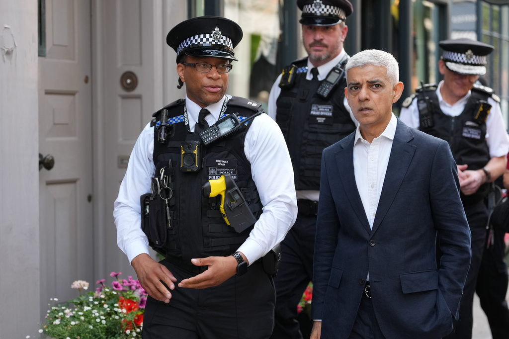 London Mayor Sadiq Khan, right, with Police Constable Opara speak, during a walkabout through the borough of Camden in London, Thursday, July 23, 2026. (AP Photo/Kirsty Wigglesworth)
