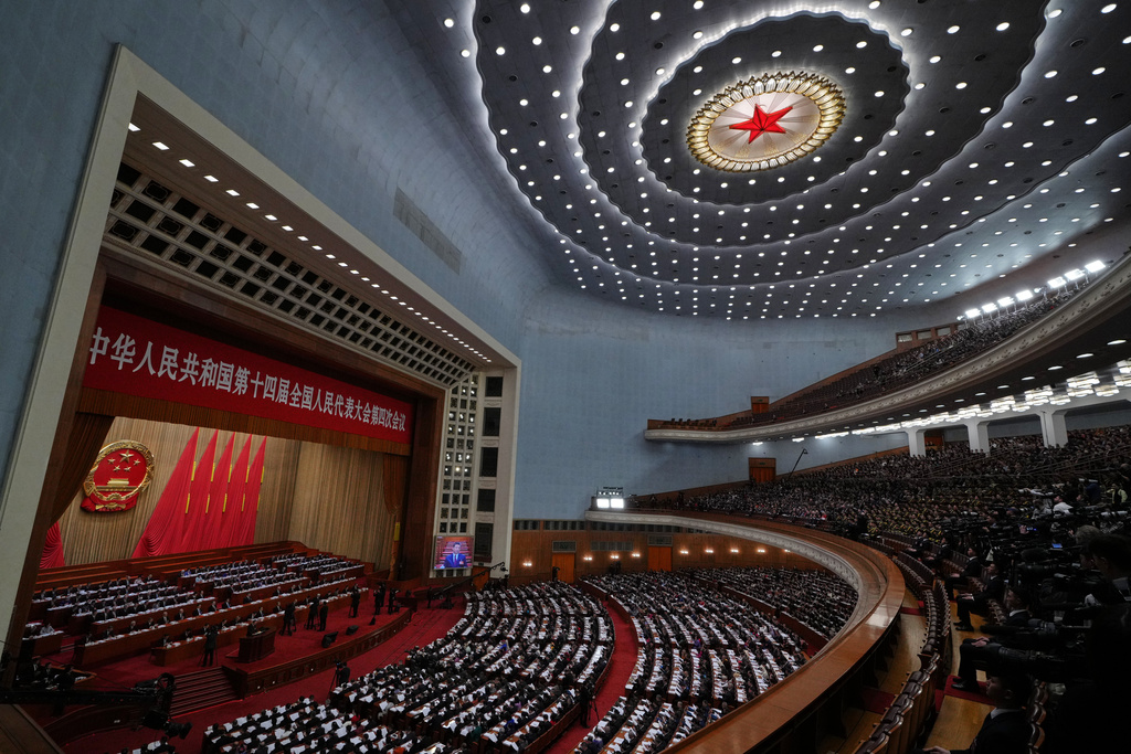 A screen showing Chinese President Xi Jinping as Premier Li Qiang delivers his work reports during the opening session of the National People's Congress (NPC) at the Great Hall of the People, in Beijing, Thursday, March 5, 2026. (AP Photo/Andy Wong)