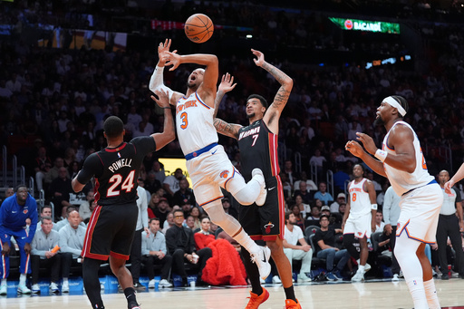 New York Knicks guard Josh Hart (3) gets fouled by Miami Heat guard Norman Powell (24) as Miami Heat center Kel'el Ware (7) looks on during the first half of an NBA basketball game, Sunday, Oct. 26, 2025, in Miami. (AP Photo/Rebecca Blackwell) New York Knicks guard Josh Hart (3) gets fouled by Miami Heat guard Norman Powell (24) as Miami Heat center Kel'el Ware (7) looks on during the first half of an NBA basketball game, Sunday, Oct. 26, 2025, in Miami. (AP Photo/Rebecca Blackwell)