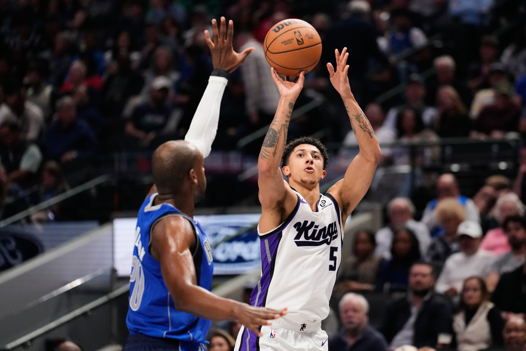 Sacramento Kings guard Nique Clifford (5) shoots over Dallas Mavericks forward Khris Middleton, left, in the first half of an NBA basketball game in Dallas, Thursday, Feb. 26, 2026. (AP Photo/Tony Gutierrez)