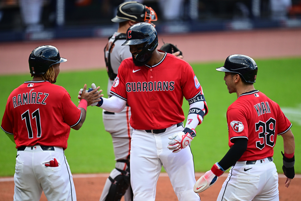 Cleveland Guardians' Jo Adell is congratulated by Jose Ramirez (11) and Steven Kwan (38) after hitting a three-run home run off San Francisco Giants starting pitcher Carson Whisenhunt during the first inning of a baseball game, Tuesday, Aug. 18, 2026, in Cleveland. (AP Photo/David Dermer)