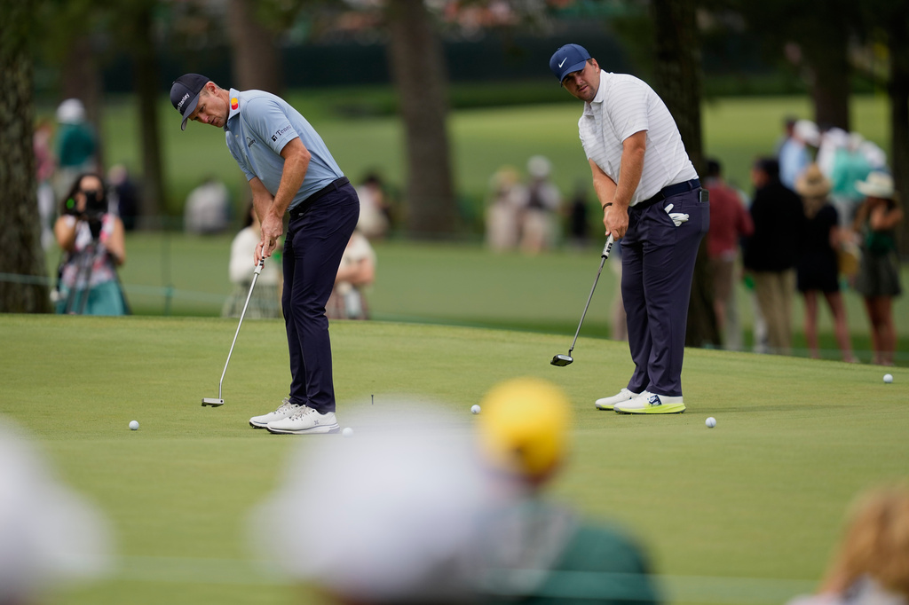 Justin Rose, of England, and Chris Gotterup putt on the seventh hole during a practice round ahead of the Masters golf tournament at the Augusta National Golf Club, Monday, April 6, 2026, in Augusta, Ga. (AP Photo/Ashley Landis)