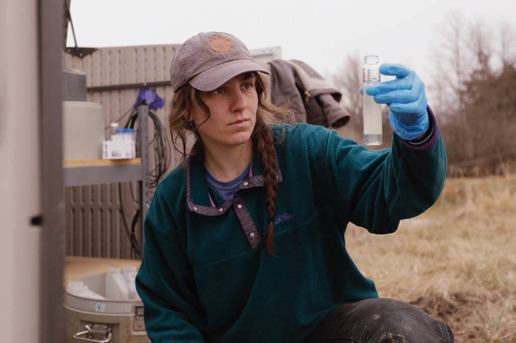 University of Vermont graduate student Delaney Bullock gathers runoff samples from two agricultural fields to be analyzed for nutrient concentrations on Thursday, March 12, 2026, in Bridport, Vt. (AP Photo/Amanda Swinhart)