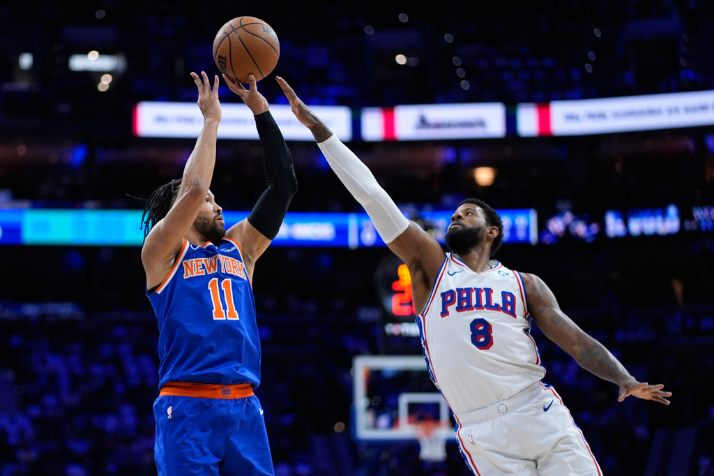 FILE - New York Knicks' Jalen Brunson, left, goes up for a shot against Philadelphia 76ers' Paul George during the first half of Game 4 in a second-round NBA basketball playoffs series, May 10, 2026, in Philadelphia. (AP Photo/Matt Slocum, File)