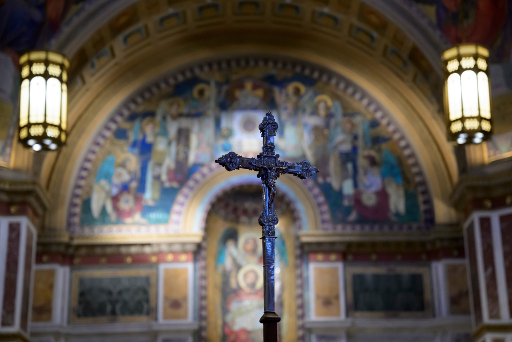 A cross is carried during an Ash Wednesday Mass at the Cathedral of St. Matthew the Apostle, Wednesday, Feb., 18, 2026, in Washington. (AP Photo/Rod Lamkey, Jr.)