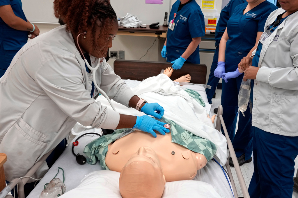 Nursing student Persis Coleman checks a manikin in the simulation lab at Forsyth Technical Community College in Winston-Salem, N.C., Thursday, Aug. 20, 2026. (AP Photo/Chuck Burton)
