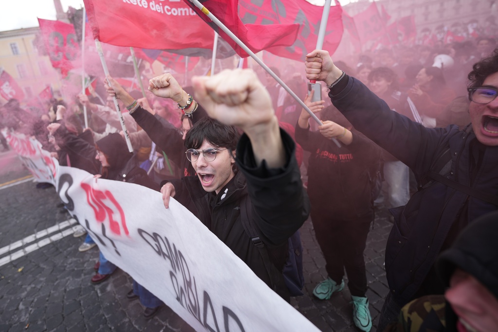 People take part in a national demonstration against the war in Iran and the March 22 referendum on the Italian justice system, in Rome, Saturday, March 14, 2026. (AP Photo/Andrew Medichini)