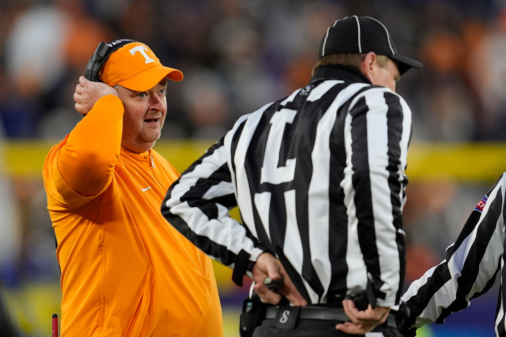 Tennessee head coach Josh Heupel talks to an official during the first half of the Music City Bowl NCAA college football game against Illinois, Tuesday, Dec. 30, 2025, in Nashville, Tenn. (AP Photo/George Walker IV)