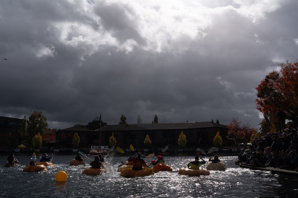 People race giant pumpkins during the West Coast Giant Pumpkin Regatta on Sunday, Oct. 19, 2025, in Tualatin, Ore. (AP Photo/Jenny Kane)