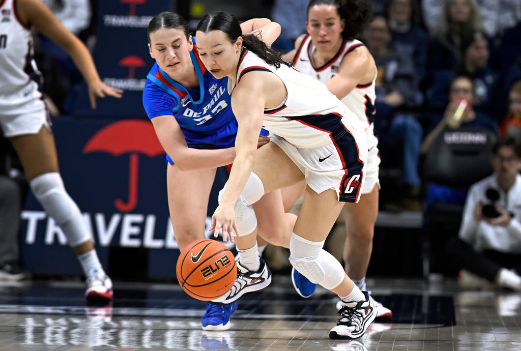 UConn guard Kayleigh Heckel, front right, steals the ball from DePaul guard Kate Novik, left, in the first half of an NCAA college basketball game, Sunday, Dec. 7, 2025, in Storrs, Conn. (AP Photo/Jessica Hill)