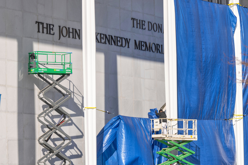 A worker on a forklift stands near the letters "The Donald" above the signage on the Kennedy Center on Friday, Dec. 19, 2025, in Washington. (AP Photo/Mark Schiefelbein)