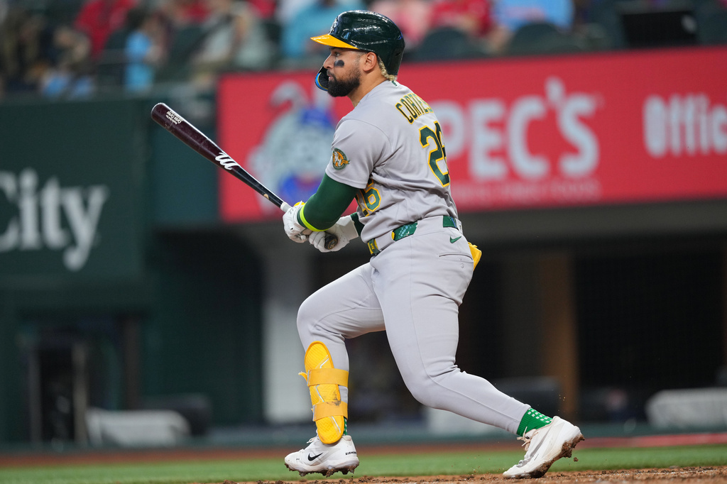 Athletics' Carlos Cortes watches his ball as he collects a single against the Texas Rangers during the fourth inning of a baseball game Sunday, April 26, 2026, in Arlington, Texas. (AP Photo/Julio Cortez)