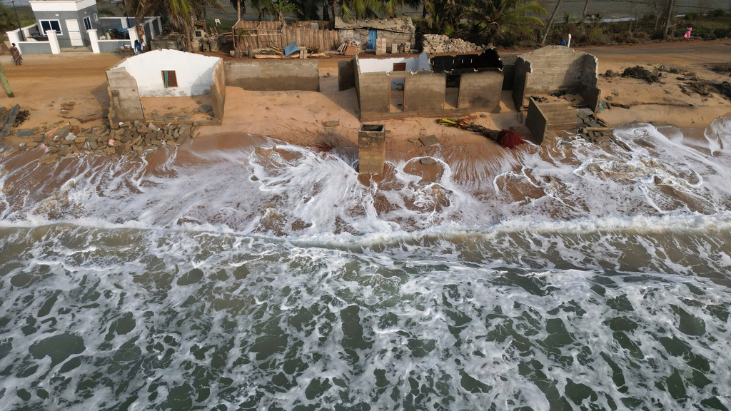 FILE - Waves lap the beach where remains of Afeli Bernice Adzo's family home stand after it was destroyed by coastal erosion in Avegadzi, Ghana, March 5, 2025 (AP Photo/Misper Apawu, File)
