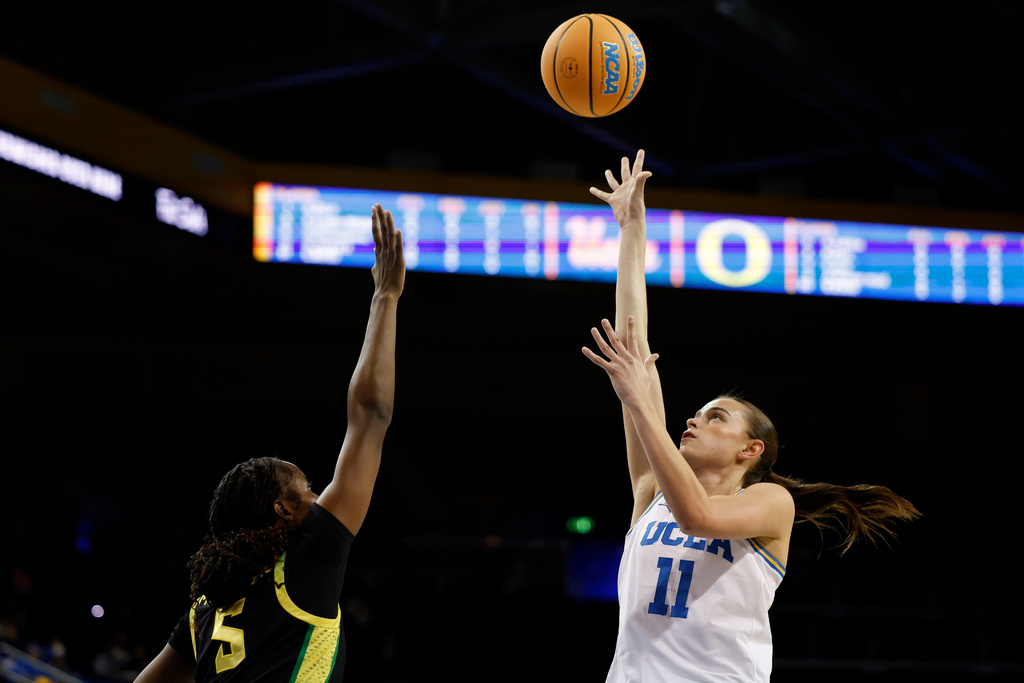 UCLA forward Gabriela Jaquez (11) drives to the basket while guarded by Oregon forward Amina Muhammad (5) during the first half of an NCAA college basketball game Sunday, Dec. 7, 2025, in Los Angeles. (AP Photo/Caroline Brehman)