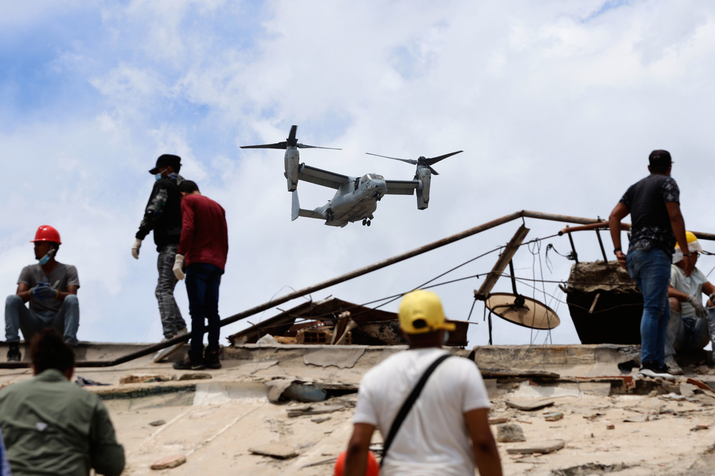 A U.S. aircraft flies over an area struck by earthquakes in La Guaira, Venezuela, Sunday, June 28, 2026. (AP Photo/Pedro Mattey)