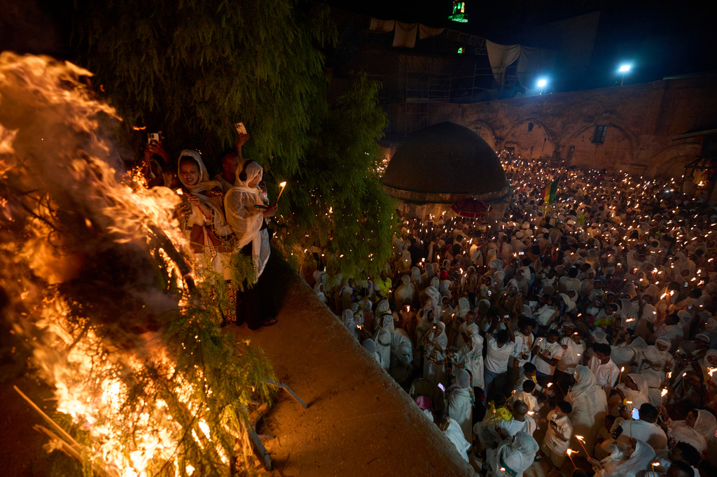 Ethiopian Orthodox Christian worshippers hold candles on the eve of the Meskel holiday at the Ethiopian monks' village, Deir Al‑Sultan, located on the rooftop of the Church of the Holy Sepulcher in Jerusalem's Old City, Saturday, Sept. 26, 2026. (AP Photo/Ohad Zwigenberg)