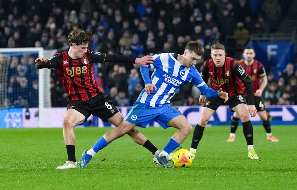 Bournemouth's Alex Scott and Brighton and Hove Albion's Brajan Gruda, right, battle for the ball during the English Premier League match between Brighton & Hove Albion and AFC Bournemouth in Brighton and Hove, England, Monday, Jan. 19, 2026. (Gareth Fuller/PA via AP)