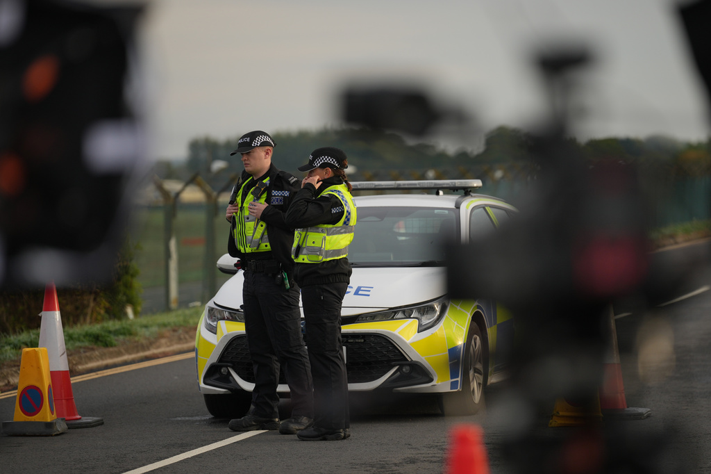 Police officers guard a road leading to RAF Fairford, after an incident in Fairford, England, Monday Sept. 28, 2026. (AP Photo/Alastair Grant)