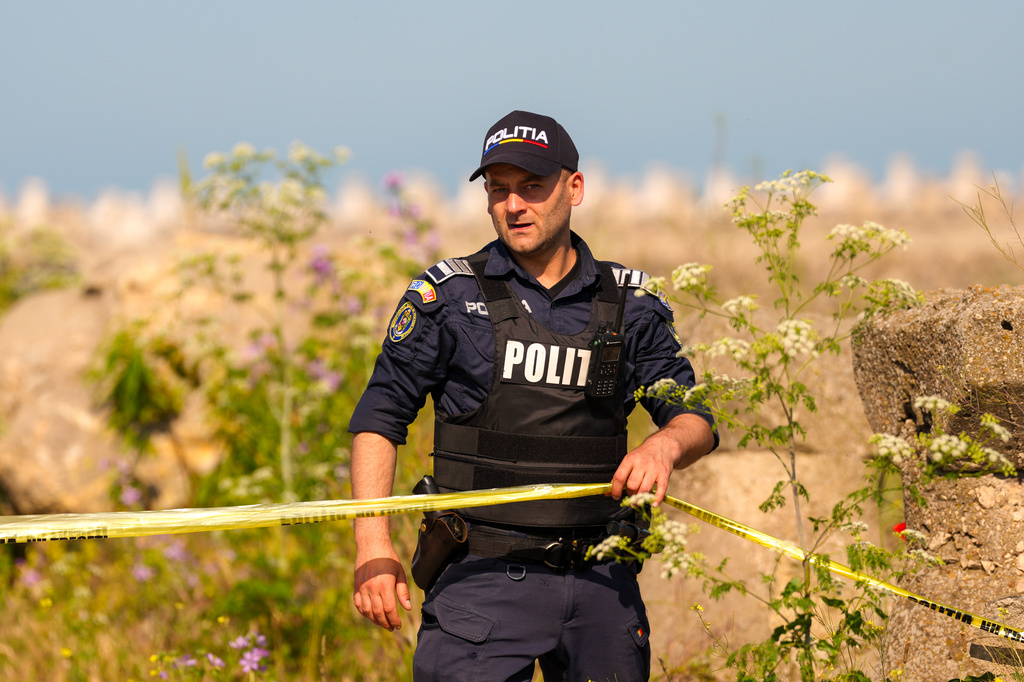 A Romanian Police officer secures an entrance in the vicinity of a damaged warehouse following the explosion of a maritime drone in the Black Sea port of Constanta, Romania, Friday, June 5, 2026. (AP Photo/Vadim Ghirda)