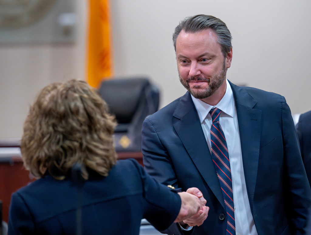 Linda Singer, an attorney representing the plaintiff, left, shakes hands with attorney Kevin Huff, representing Meta, after they made closing arguments, Monday, March 23, 2026, in state court, in Santa Fe, N.M., in a trial where the social media conglomerate is accused of misleading its users about how safe its platforms are for children. (Eddie Moore/The Albuquerque Journal via AP, Pool)