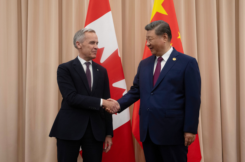 FILE - Canadian Prime Minister Mark Carney, left, shakes hands with Chinese President Xi Jinping at the start of a meeting in Gyeongju, South Korea, Oct. 31, 2025. (Adrian Wyld/The Canadian Press via AP, File)