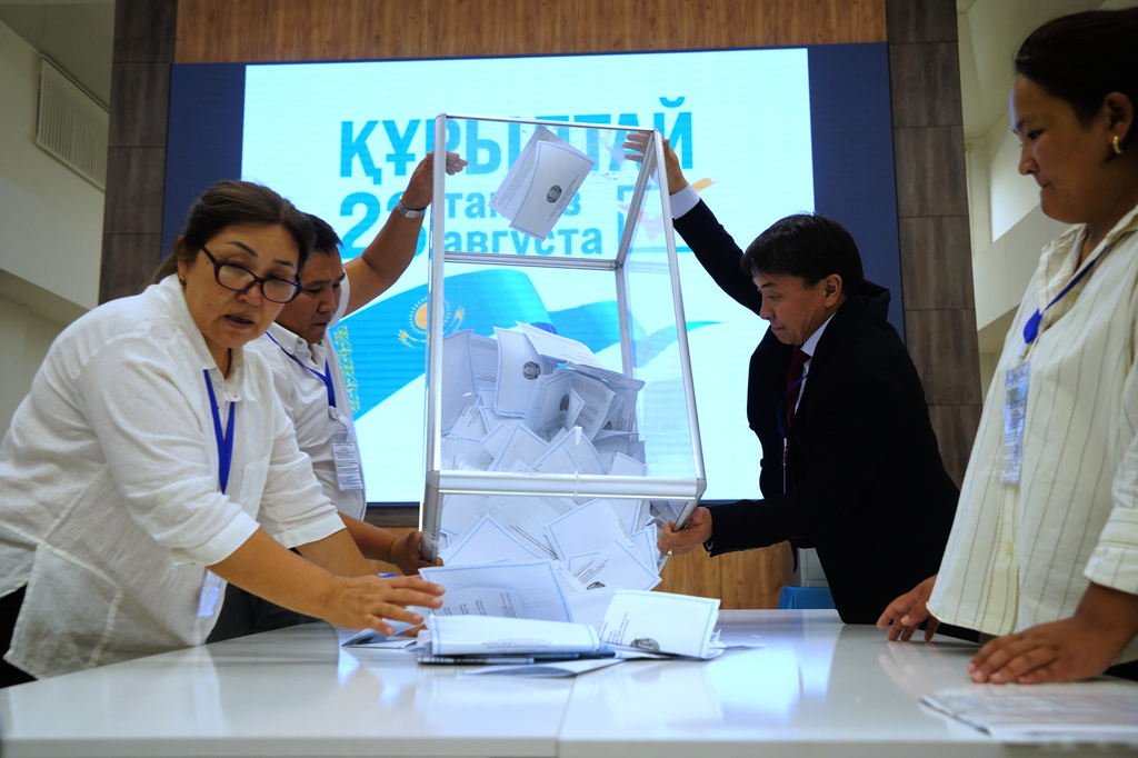 Election commission members count ballots at a polling station during early parliamentary elections in Almaty, Kazakhstan, Sunday, Aug. 23, 2026. (AP Photo/Vladimir Tretyakov)