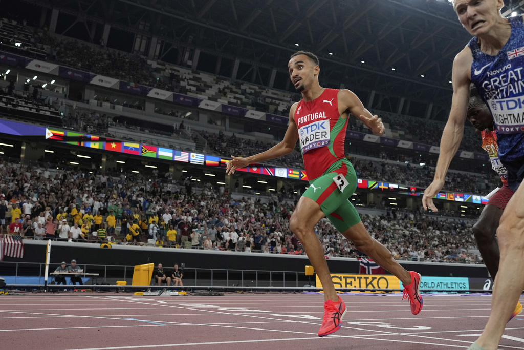 Portugal's Isaac Nader, left, crosses the finish line ahead of Britain's Jake Wightman to win the men's 1,500 meters final at the World Athletics Championships in Tokyo, Wednesday, Sept. 17, 2025. (AP Photo/David J. Phillip)
