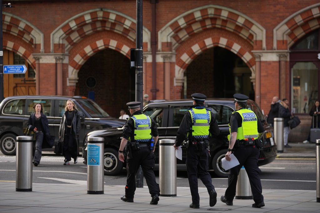 FILE - Police officers patrol the King's Cross train station, in London, Monday, Nov. 3, 2025. (AP Photo/Kin Cheung, File)