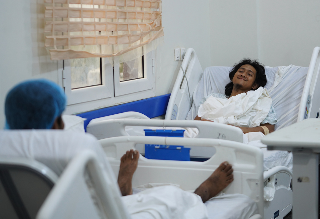 Indonesian crew member Muhammad Al Taindo , right, receives medical treatment at 2 December Hospital in Mokha, Yemen, Wednesday, Aug. 12, 2026, after the cargo ship Tihama was struck in a Houthi attack in the Bab al-Mandab Strait off Yemen's Dhubab district on Aug. 10, 2026. (AP Photo/Abdulnasser Alseddik)