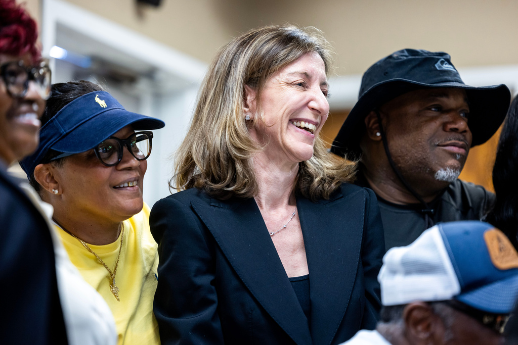 FILE - Former Rep. Elaine Luria, D-Va., stands in a group photo with members of the Amalgamated Transit Union Local 1177 on July 9, 2026, in Norfolk, Va. (AP Photo/Kendall Warner, File)