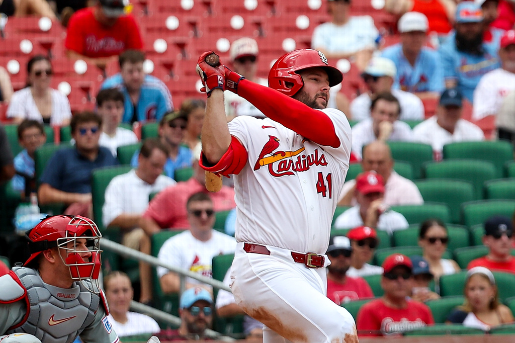 St. Louis Cardinals' Alec Burleson follows through on and RBI single during the seventh inning of a baseball game against the Philadelphia Phillies Wednesday, Aug. 12, 2026, in St. Louis. (AP Photo/Scott Kane)