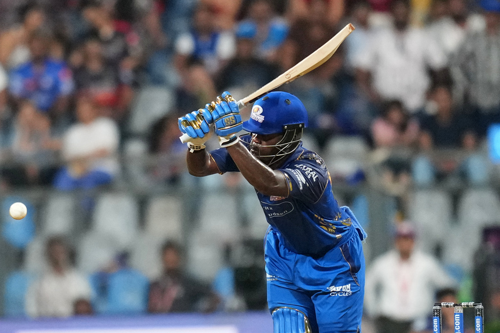 Mumbai Indians' Shefane Rutherford hits a boundary during the Indian Premier League cricket match between Mumbai Indians and Royal Challengers Bengaluru, in Mumbai , India, Sunday, April 12, 2026. (AP Photo/Rafiq Maqbool)