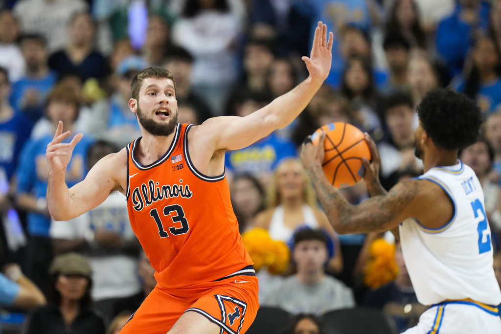 Illinois center Tomislav Ivisic (13) defends UCLA guard Donovan Dent (2) during the first half of an NCAA college basketball game in Los Angeles, Saturday, Feb. 21, 2026. (AP Photo/Jae C. Hong)