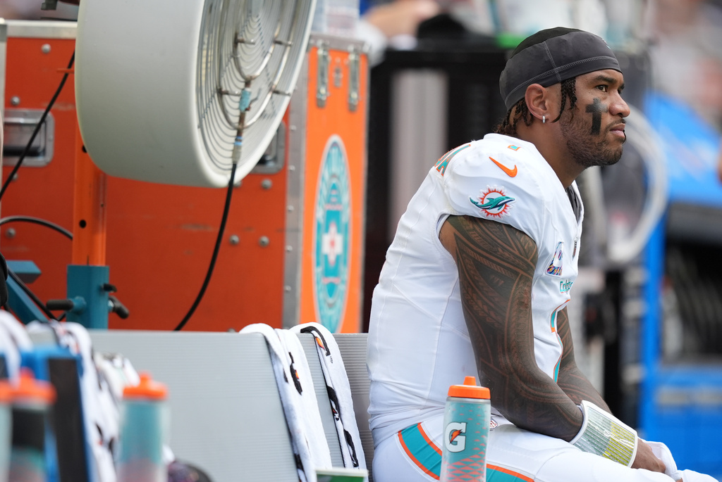 Miami Dolphins quarterback Tua Tagovailoa looks on from the sidelines during the first half of an NFL football game against the Los Angeles Chargers Sunday, Oct. 12, 2025, in Miami Gardens, Fla. (AP Photo/Rebecca Blackwell)