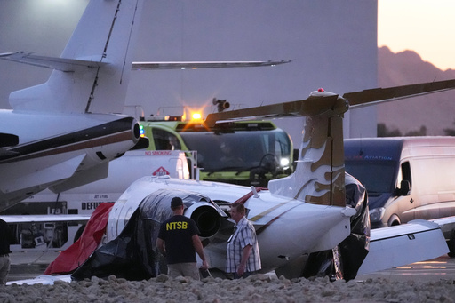 FILE - Investigators look at a crashed Learjet at Scottsdale Airport after it collided with a parked plane Feb. 10, 2025, in Scottsdale, Ariz. (AP Photo/Ross D. Franklin, File) FILE - Investigators look at a crashed Learjet at Scottsdale Airport after it collided with a parked plane Feb. 10, 2025, in Scottsdale, Ariz. (AP Photo/Ross D. Franklin, File)