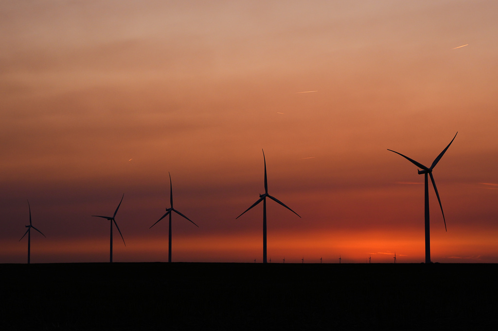 FILE - Wind turbines are silhouetted against the sky at dusk May 15, 2026, near Cimarron, Kan. (AP Photo/Charlie Riedel, File)