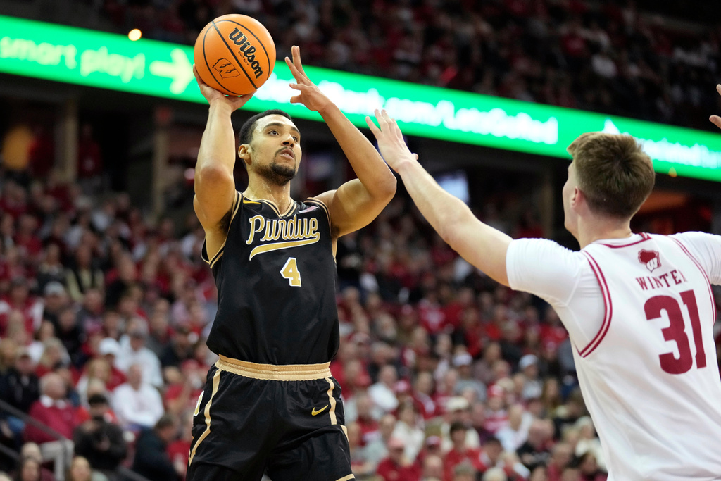 Purdue forward Trey Kaufman-Renn (4) scores against Wisconsin forward Nolan Winter (31) during the first half of an NCAA college basketball game Saturday, Jan. 3, 2026, in Madison, Wis. (AP Photo/Kayla Wolf)