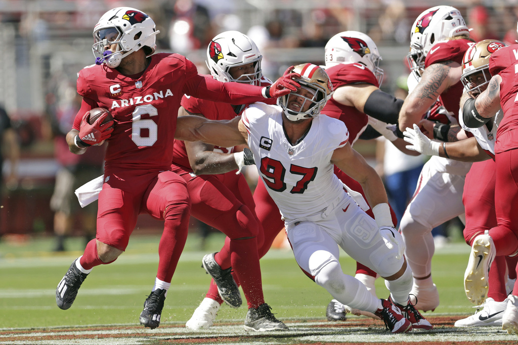 San Francisco 49ers' Nick Bosa (97) tries to stop Arizona Cardinals' James Connor in the first quarter of an NFL football game in Santa Clara, Calif., Sunday, Sept. 21, 2025. (Scott Strazzante/San Francisco Chronicle via AP)