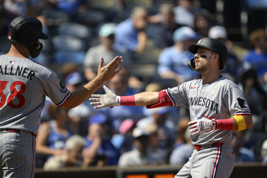 Minnesota Twins' Kody Clemens, right, celebrates after his two-run home run with teammate Matt Wallner, left, during the fourth inning of a baseball game against the Kansas City Royals in Kansas City, Mo., Sunday, Sept. 7, 2025. (AP Photo/Reed Hoffmann)