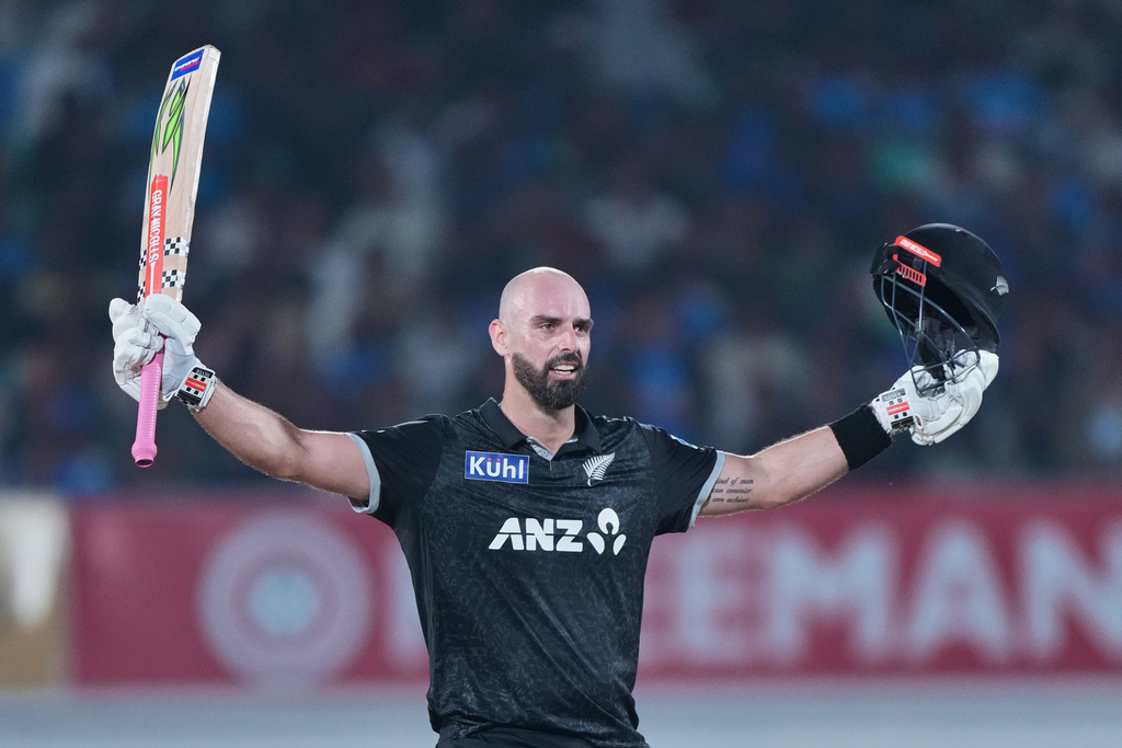 New Zealand's Daryl Mitchell celebrates after scoring a century during the second One Day International cricket match between India and New Zealand in Rajkot, India, Wednesday, Jan. 14, 2026. (AP Photo/Ajit Solanki)