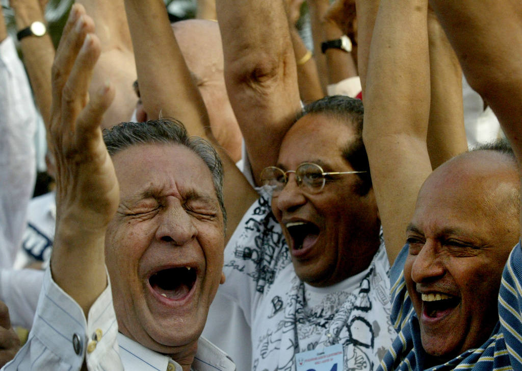 FILE - Members of laughter clubs participate in a laughter competition for the elderly to celebrate World Laughter Day in Mumbai, India, May 6, 2007. (AP Photo/Gautam Singh, File)