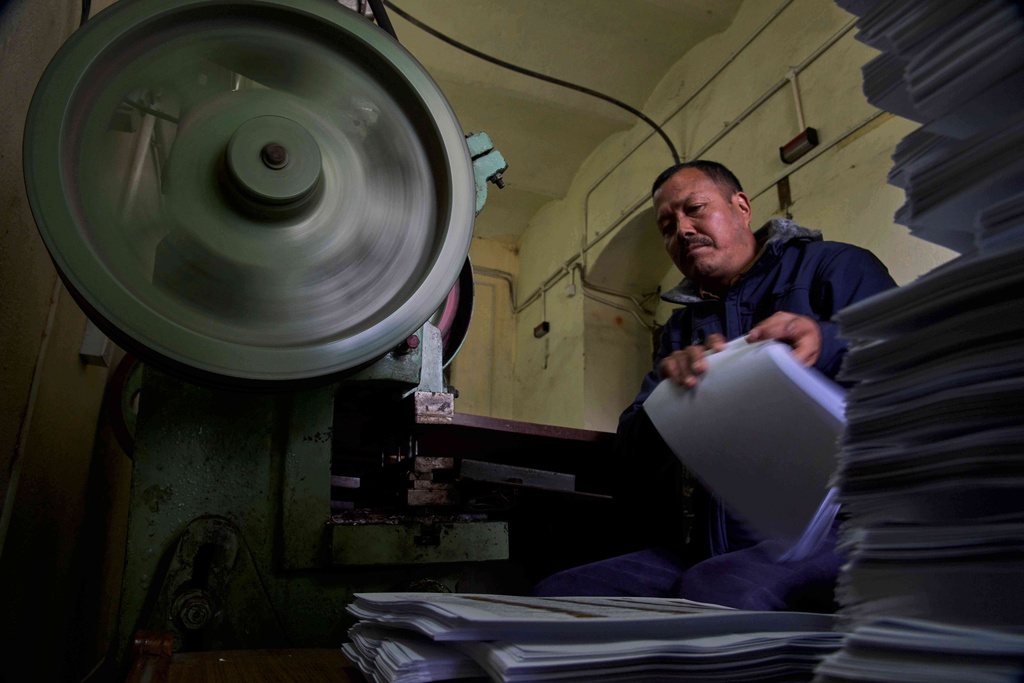 A staff member binds a voter list for distribution to various regions across the country ahead of the general election scheduled for March 5, at the Election Commission in Kathmandu, Nepal, Friday, Jan. 30, 2026. (AP Photo/Niranjan Shrestha,File)