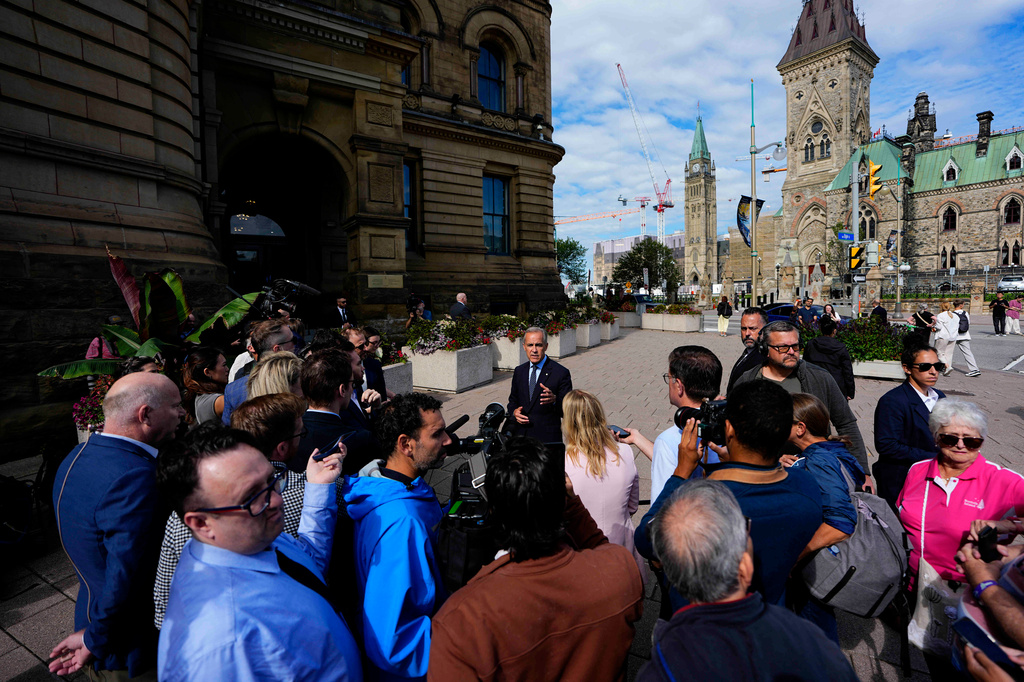 Prime Minister Mark Carney speaks to journalists as he arrives at the Office of the Prime Minister and Privy Council in Ottawa, Canada, Tuesday, Sept. 1, 2026. (Justin Tang/The Canadian Press via AP)