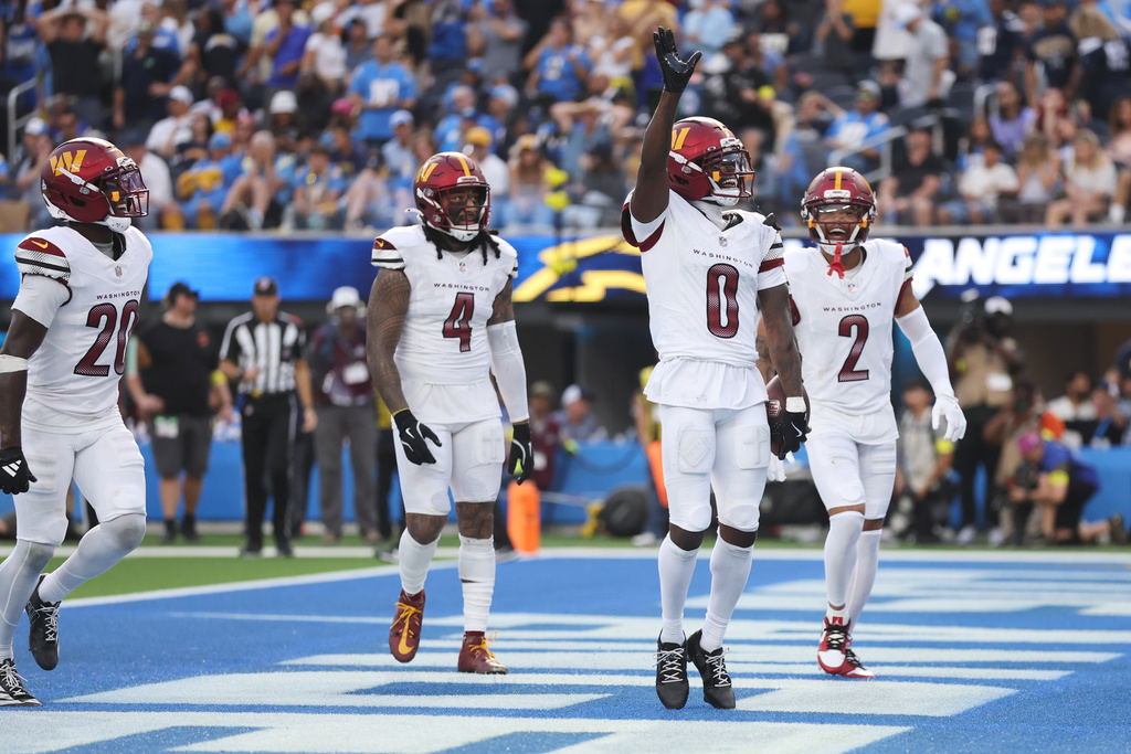 Washington Commanders cornerback Mike Sainristil (0) celebrates after intercepting a pass during the second half of an NFL football game against the Los Angeles Chargers, Sunday, Oct. 5, 2025, in Inglewood, Calif. (AP Photo/Eric Thayer)