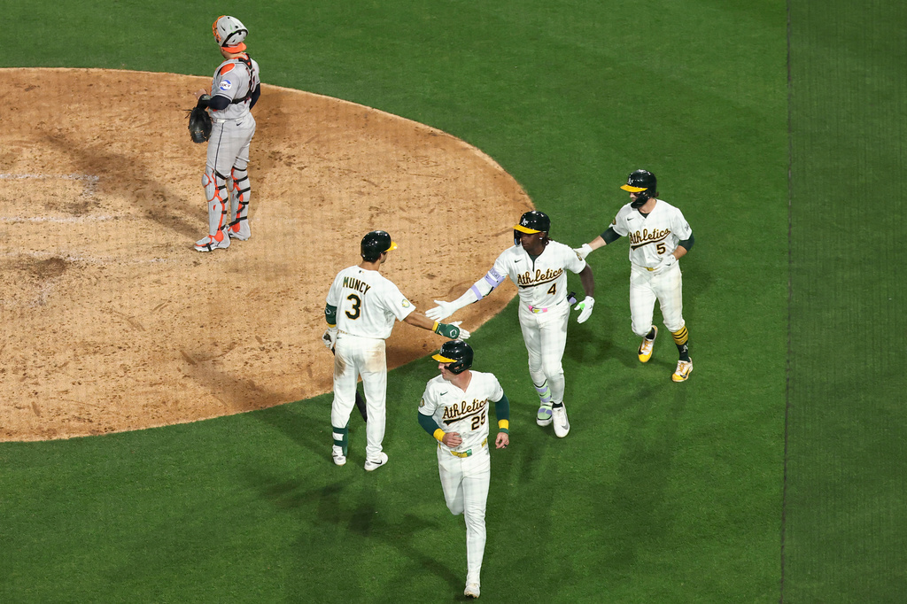 Athletics' Lawrence Butler (4) celebrates after hitting a three-run home run during the fourth inning of a home-opener baseball game against the Houston Astros, Friday, April 3, 2026, in West Sacramento, Calif. (AP Photo/Sara Nevis)