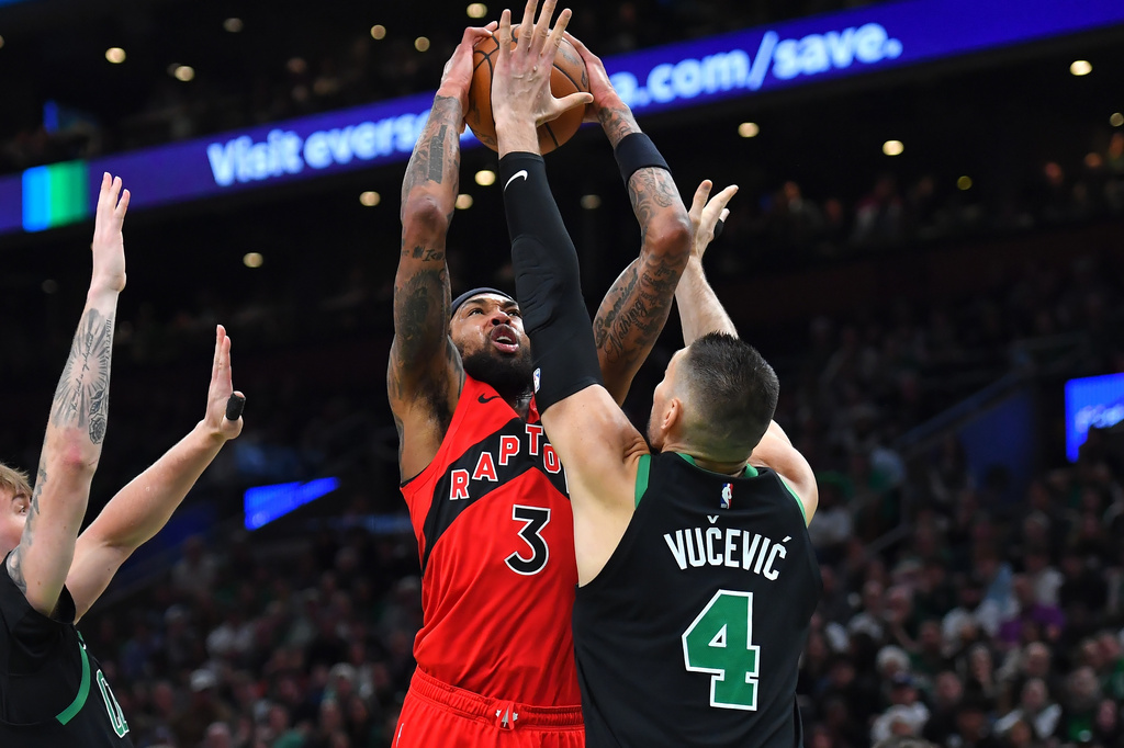 Toronto Raptors forward Brandon Ingram (3) takes a shot at the basket as Boston Celtics center Nikola Vucevic (4) defends in the first half of an NBA basketball game, Sunday, April 5, 2026, in Boston. (AP Photo/Steven Senne)