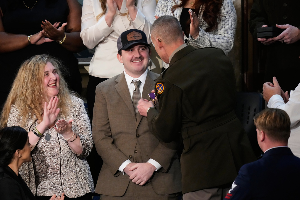West Virginia National Guard Staff Sgt. Andrew Wolfe is awarded a Purple Heart during President Donald Trump's State of the Union address to a joint session of Congress in the House chamber at the U.S. Capitol in Washington, Tuesday, Feb. 24, 2026. (AP Photo/Alex Brandon)